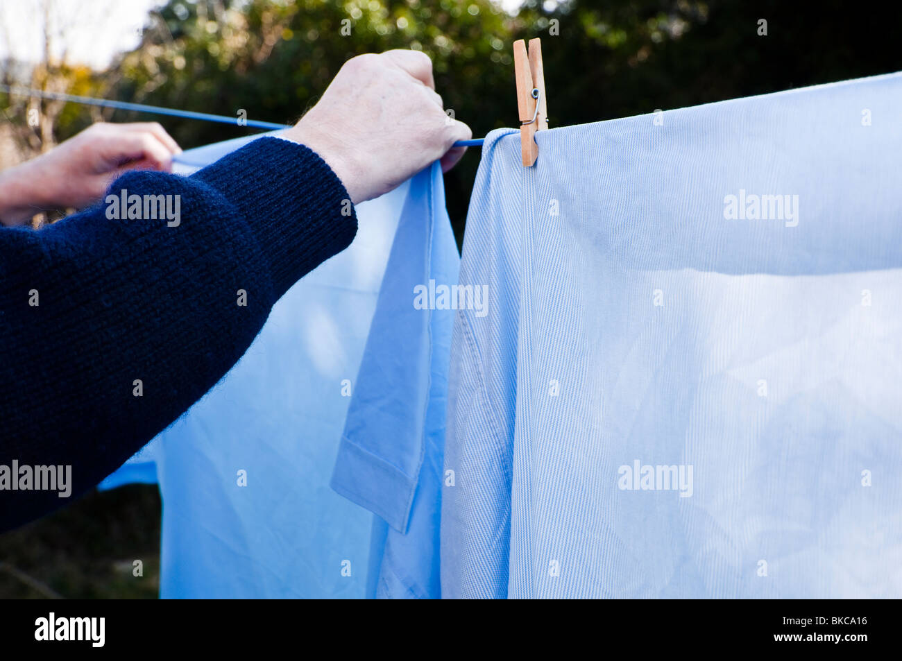 Man hanging out the washing on the line Stock Photo