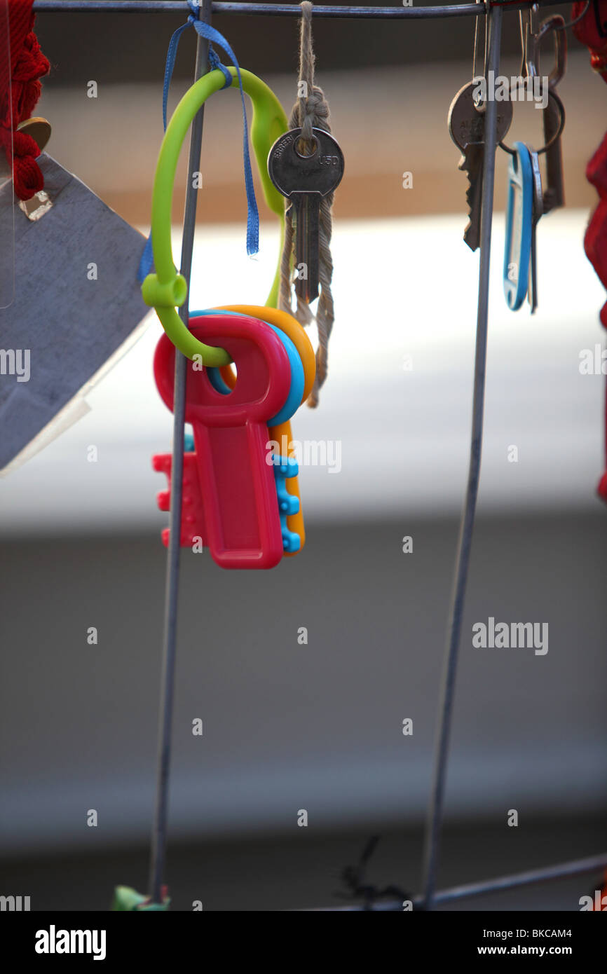 A set of childrens toy plastic keys hang on a barrier as part of a wider protest against the lack progress in L'Aquila Stock Photo