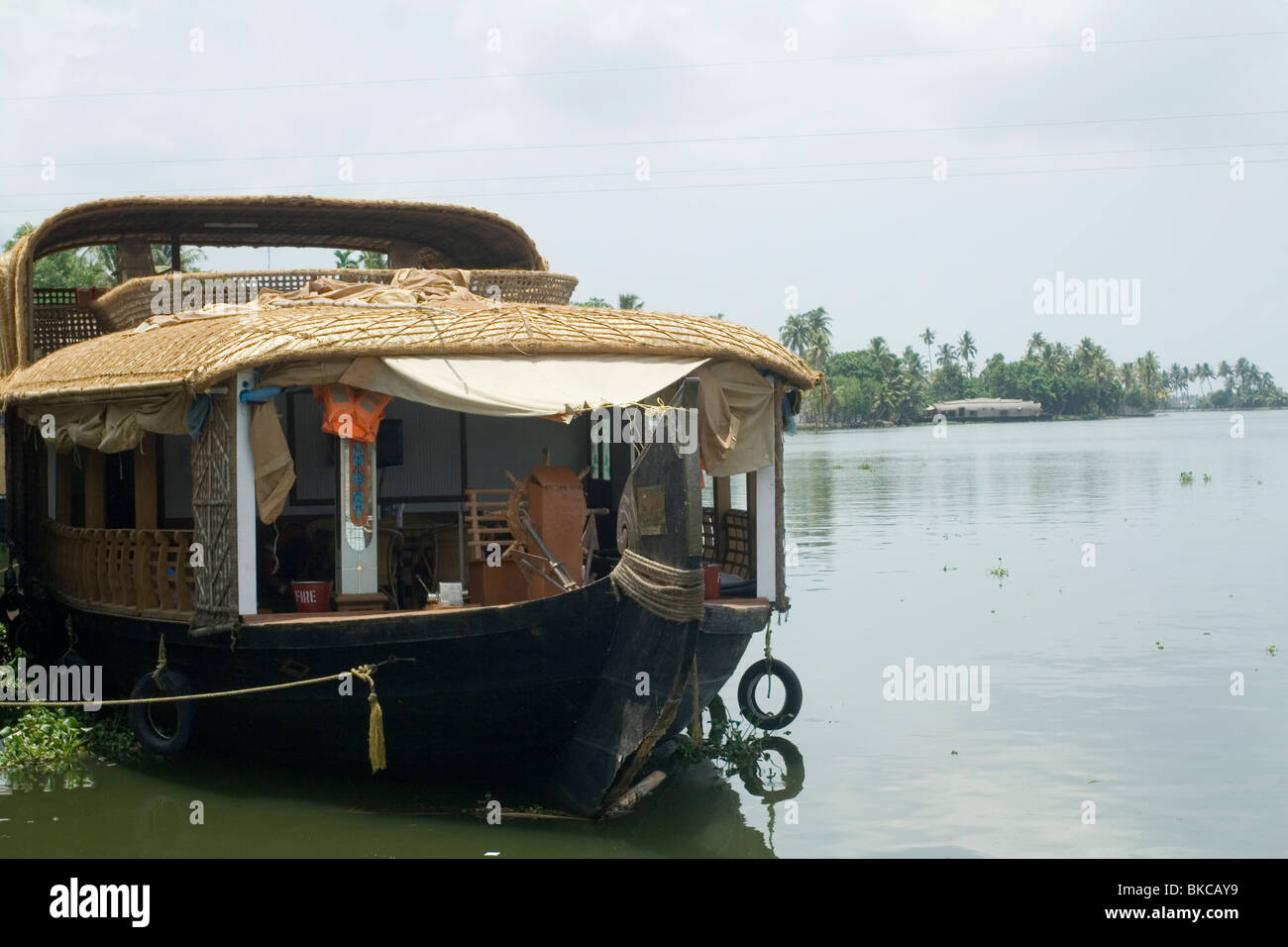 A houseboat with sundeck anchored by the side of the backwaters in kerala Stock Photo