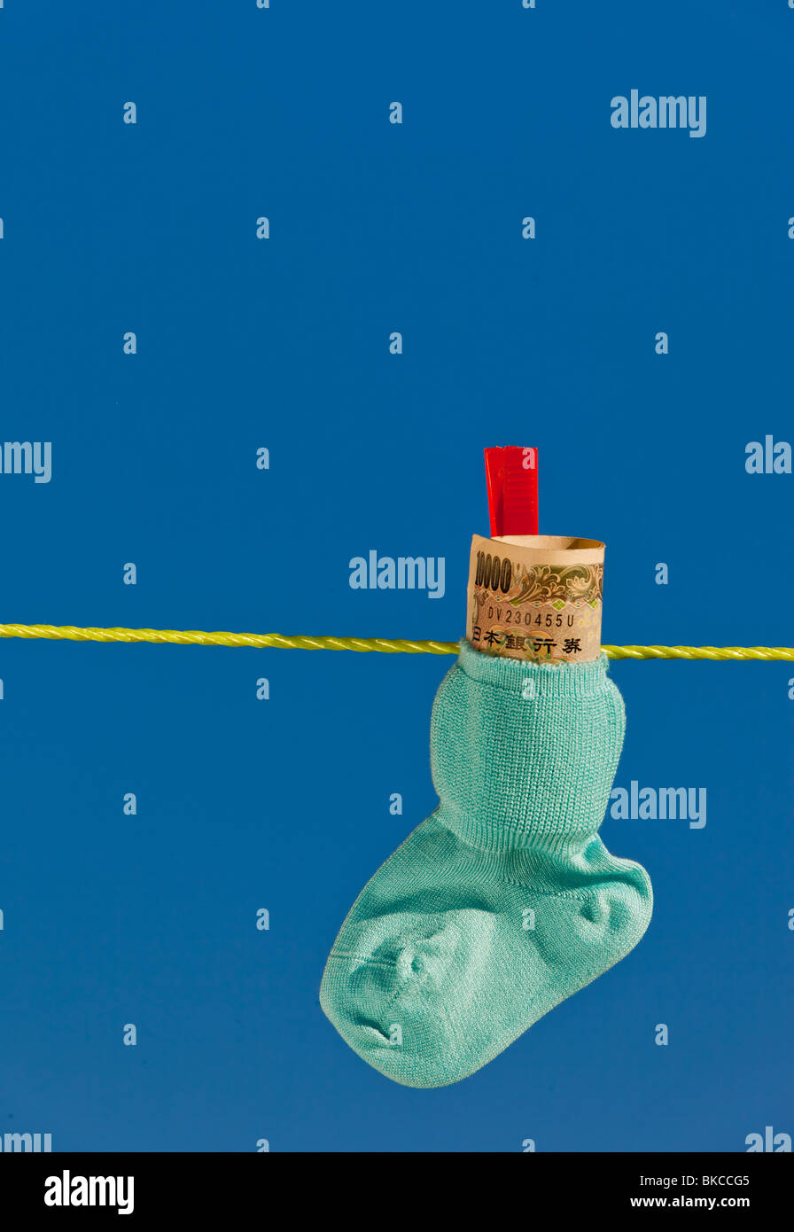 Baby socks on clothesline with Yen notes from Japan Stock Photo Alamy