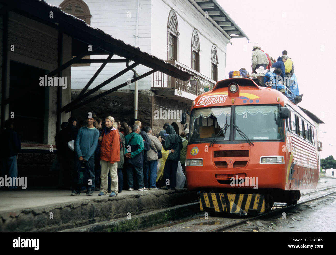 Railbus at the station in Alausi, Ecuador (above the Devil's Nose), with passengers on the roof. Stock Photo