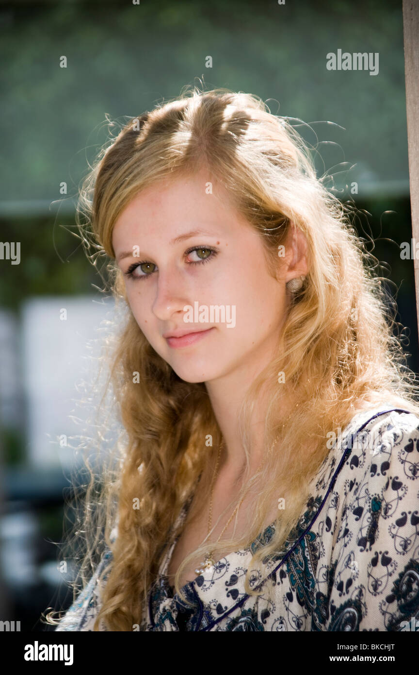 Portrait Of A Blonde Green Eyed Teenage Girl Looking Into Camera