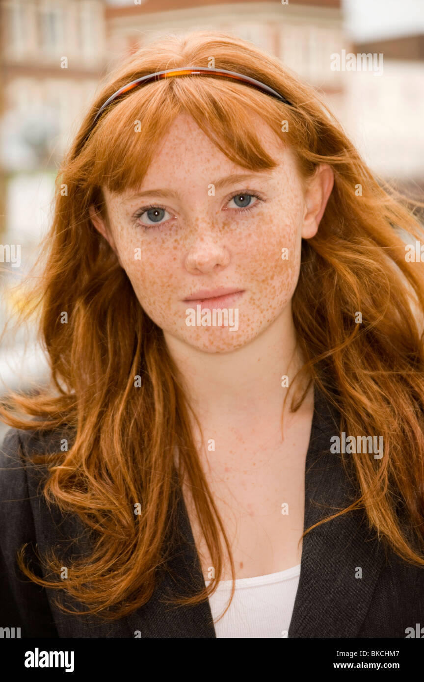 portrait of a teenage girl with red hair blue eyes and lots of freckles Stock Photo