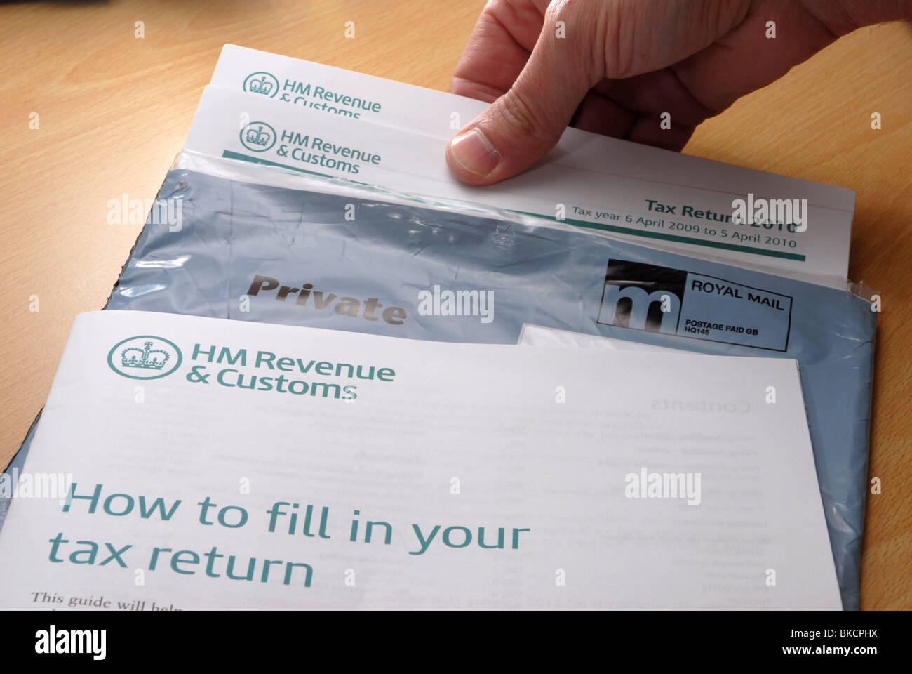 Its that time of year again.  Tax Return forms being taken out of the envelope Stock Photo