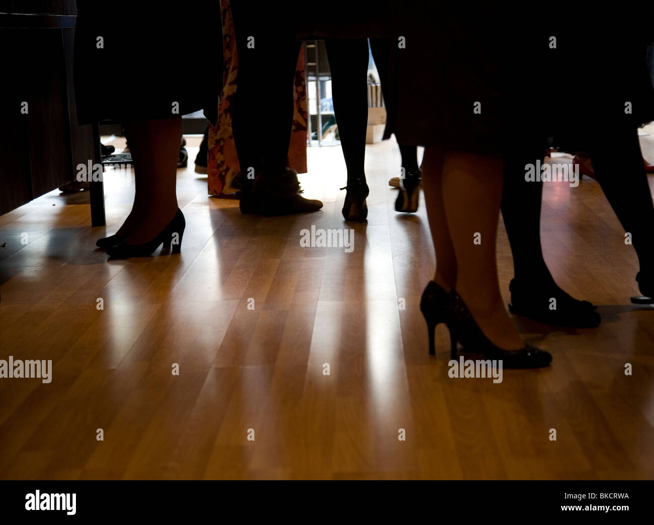 feet and heels on laminate flooring Stock Photo Alamy