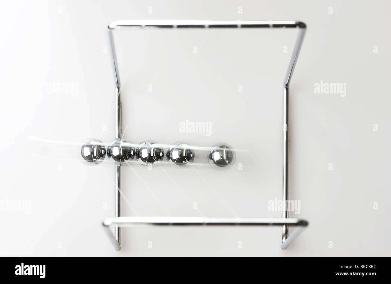 Pendulum, chrome balls, toy, gives impulses. Newton pendulum. Stock Photo