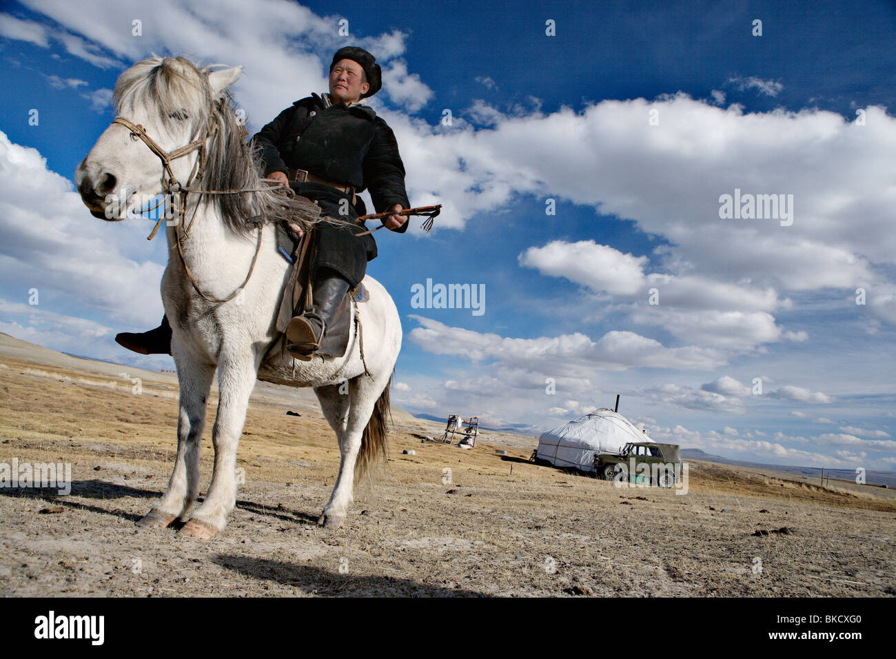 Nomad man in front of his ger (yurt or felt tent) near Tavan Bogd ...