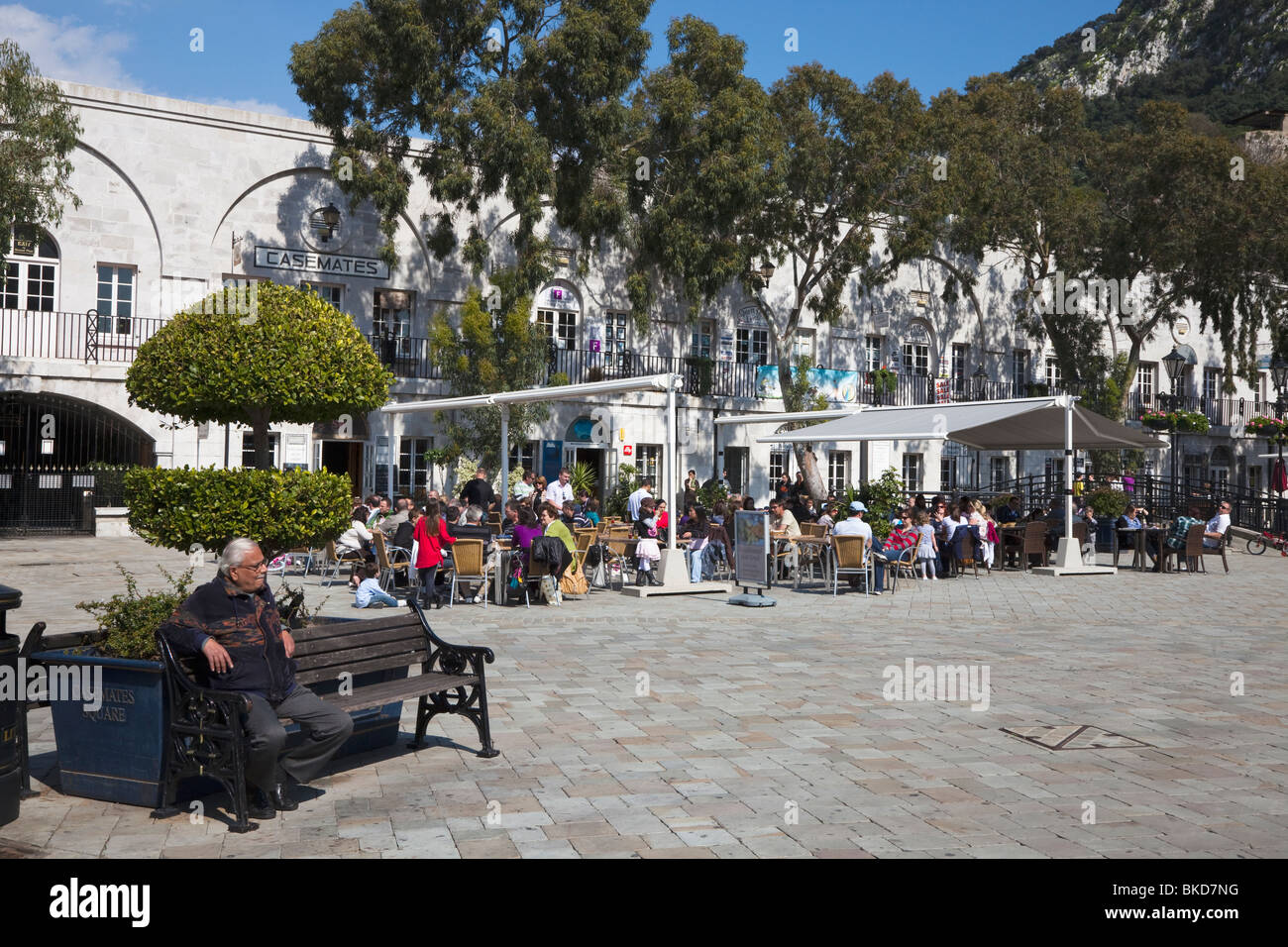Tourists sitting at outdoor tables in the cafes and restaurants in Grand Casements Square, Gibraltar Stock Photo