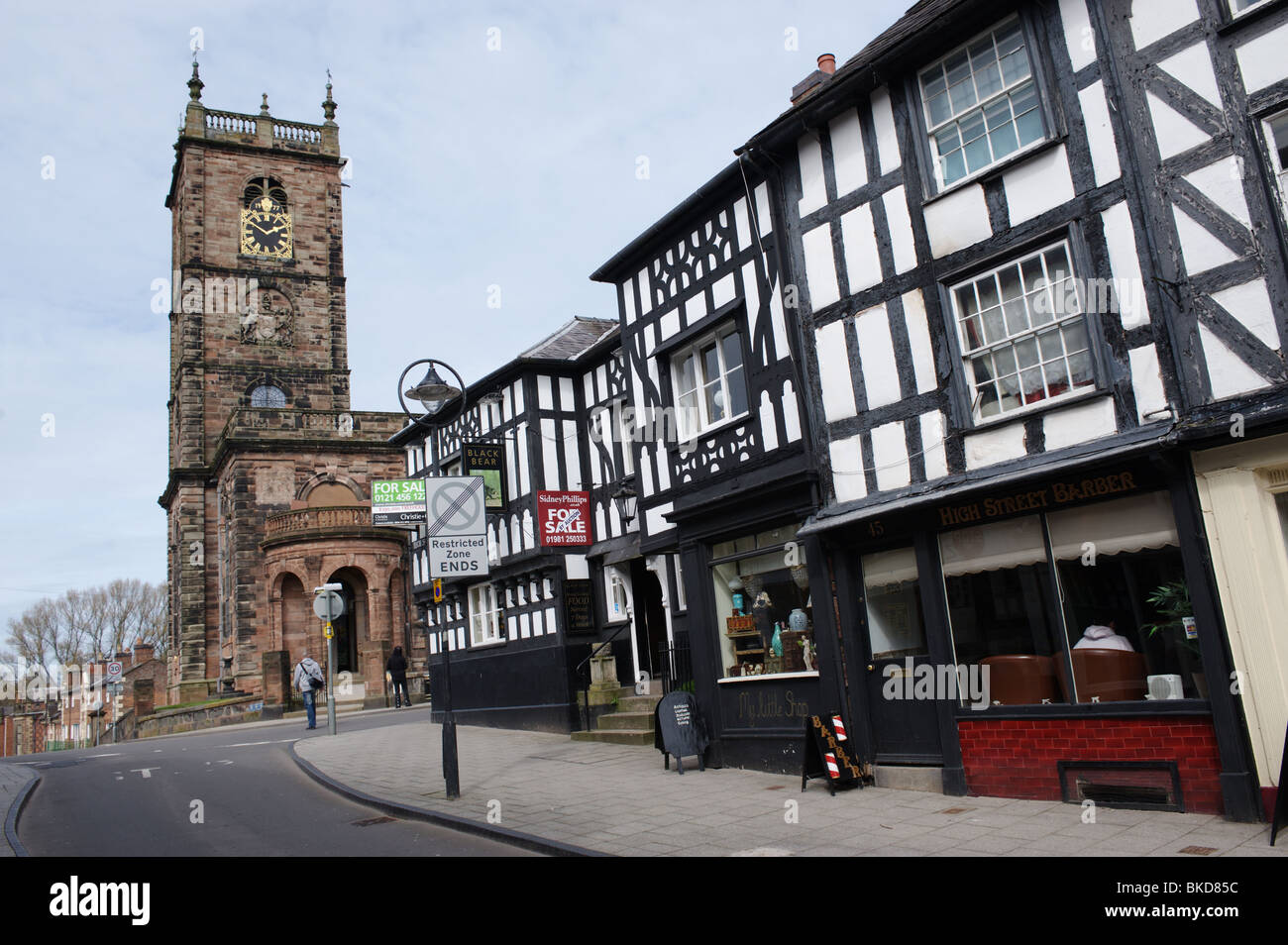 Whitchurch a market town in Shropshire, England. UK Looking up High Street to St Alkmund's Parish Church and the Black Bear pub Stock Photo