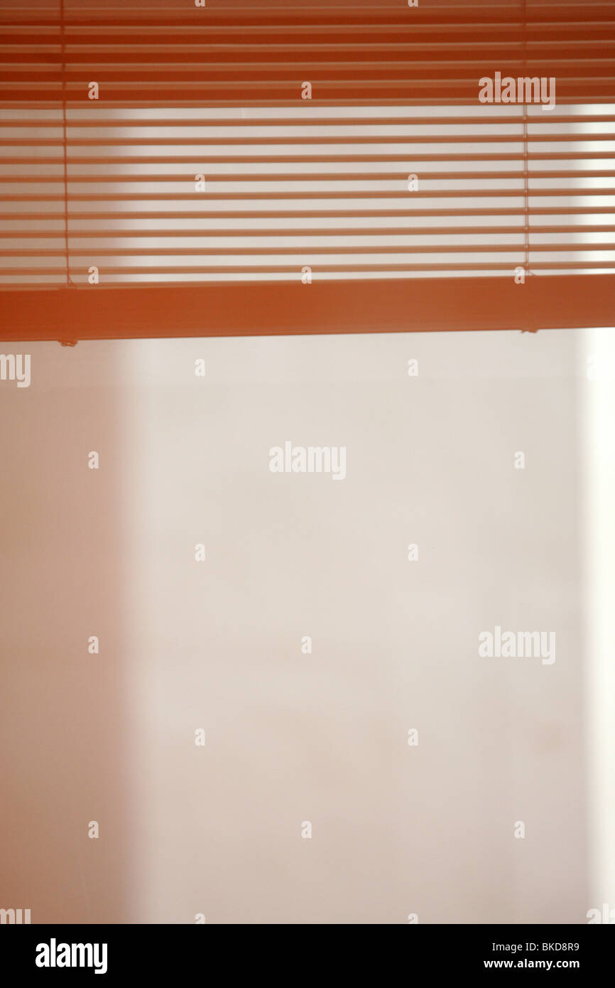 Window blinds reflected on a wall. Stock Photo
