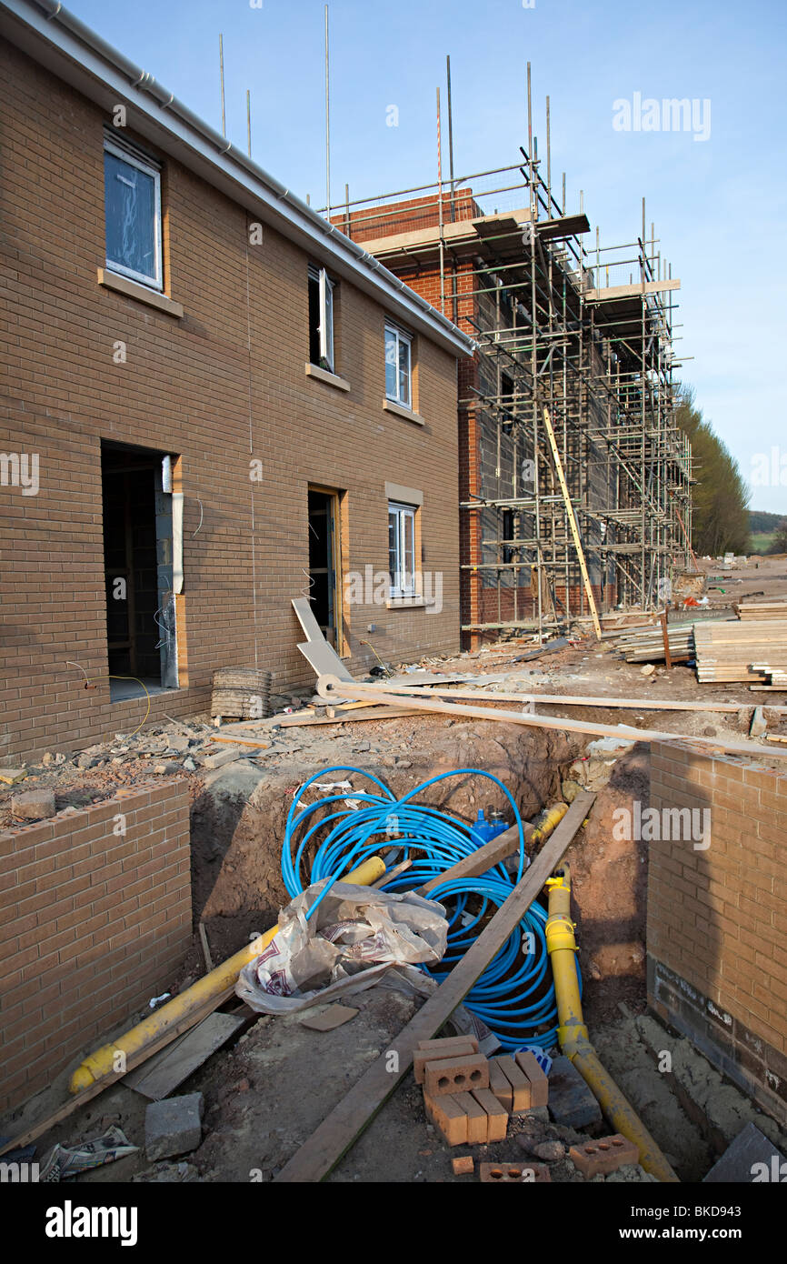Houses being built on new housing estate with pipework showing