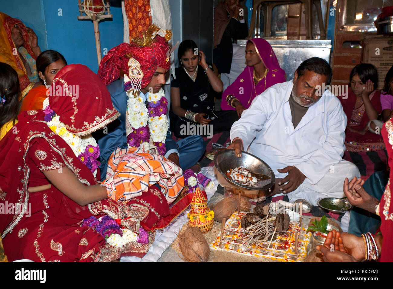 Indian brahmin (priest) marrying a couple. Pushkar. Rajasthan. India I Stock Photo