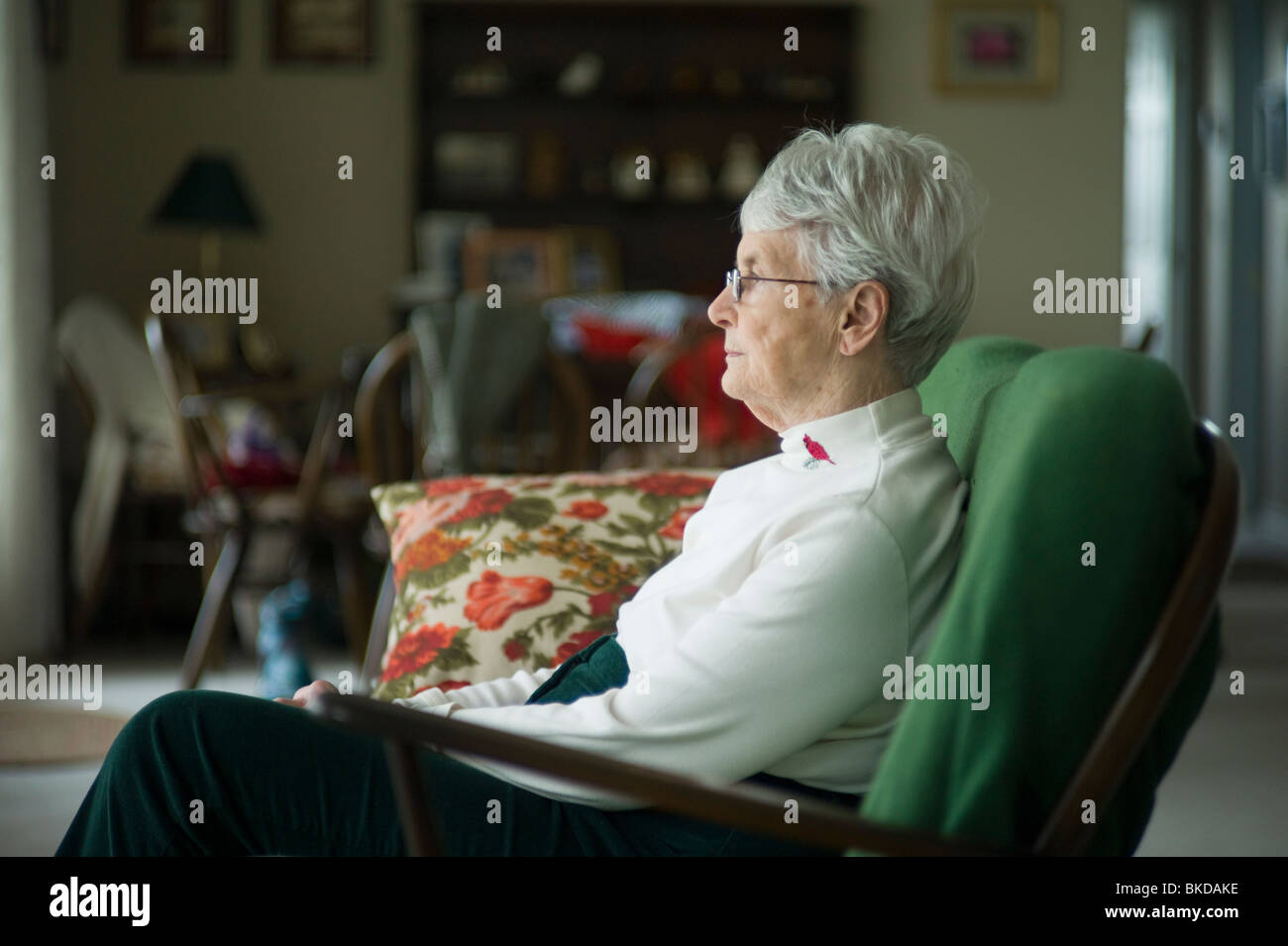 Old woman sitting on living room couch Stock Photo - Alamy