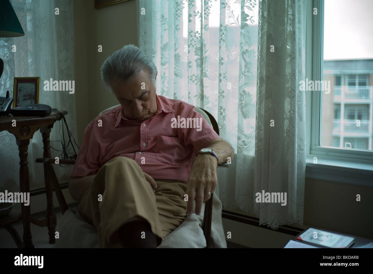Old man sleeping in living room chair Stock Photo Alamy