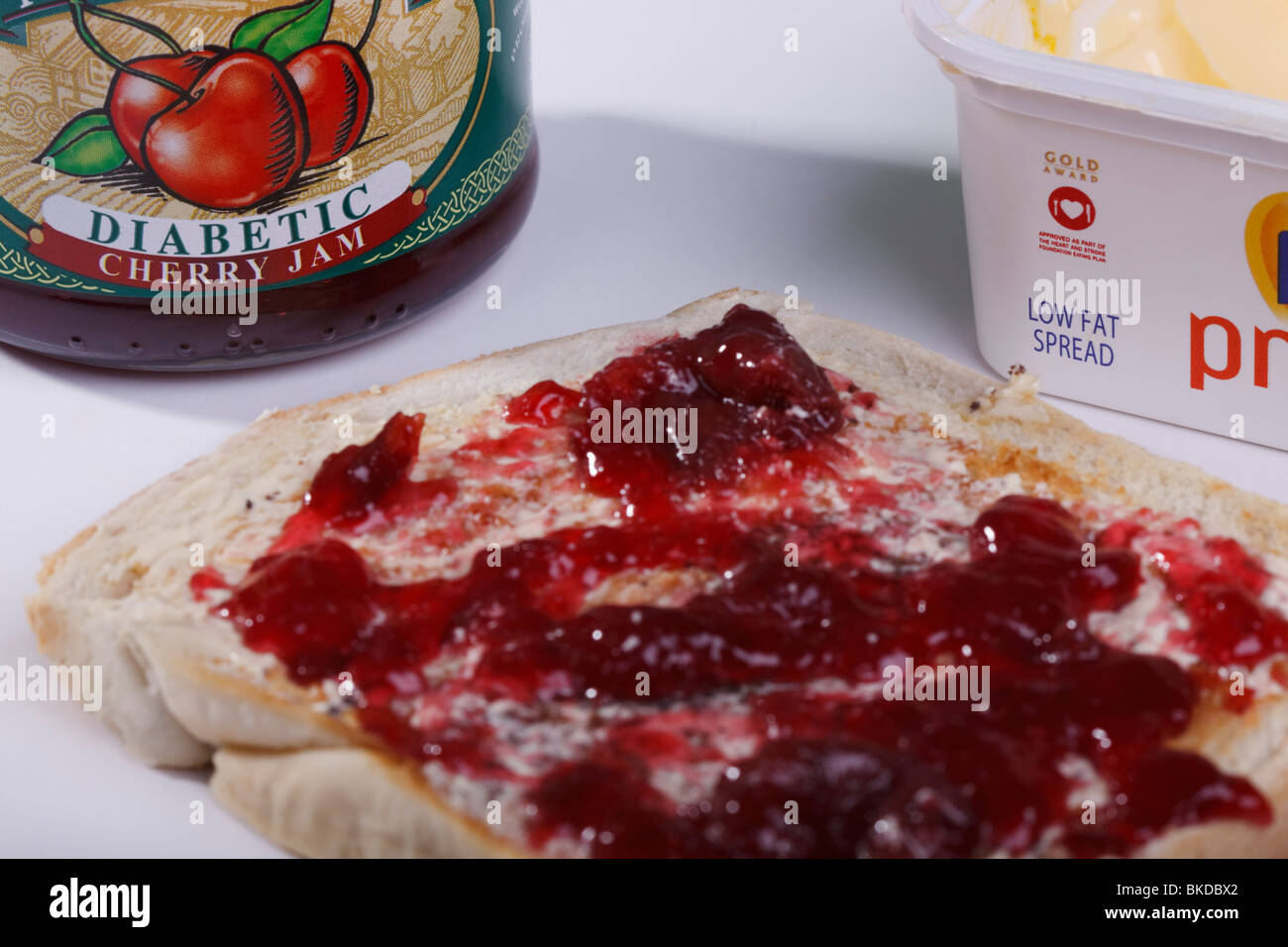 A slice of toast with low fat spread and special diabetic cherry jam