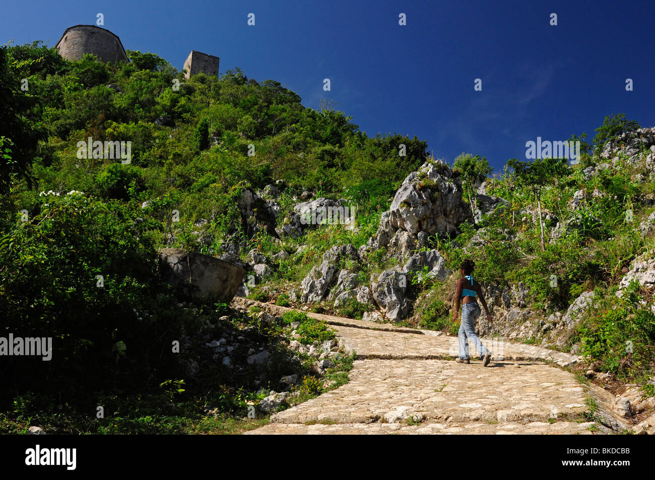 African American tourist hiking up to the Citadel, Milot, Cap Haitien, Haiti, Hispaniola, Greater Antilles, Caribbean, America Stock Photo