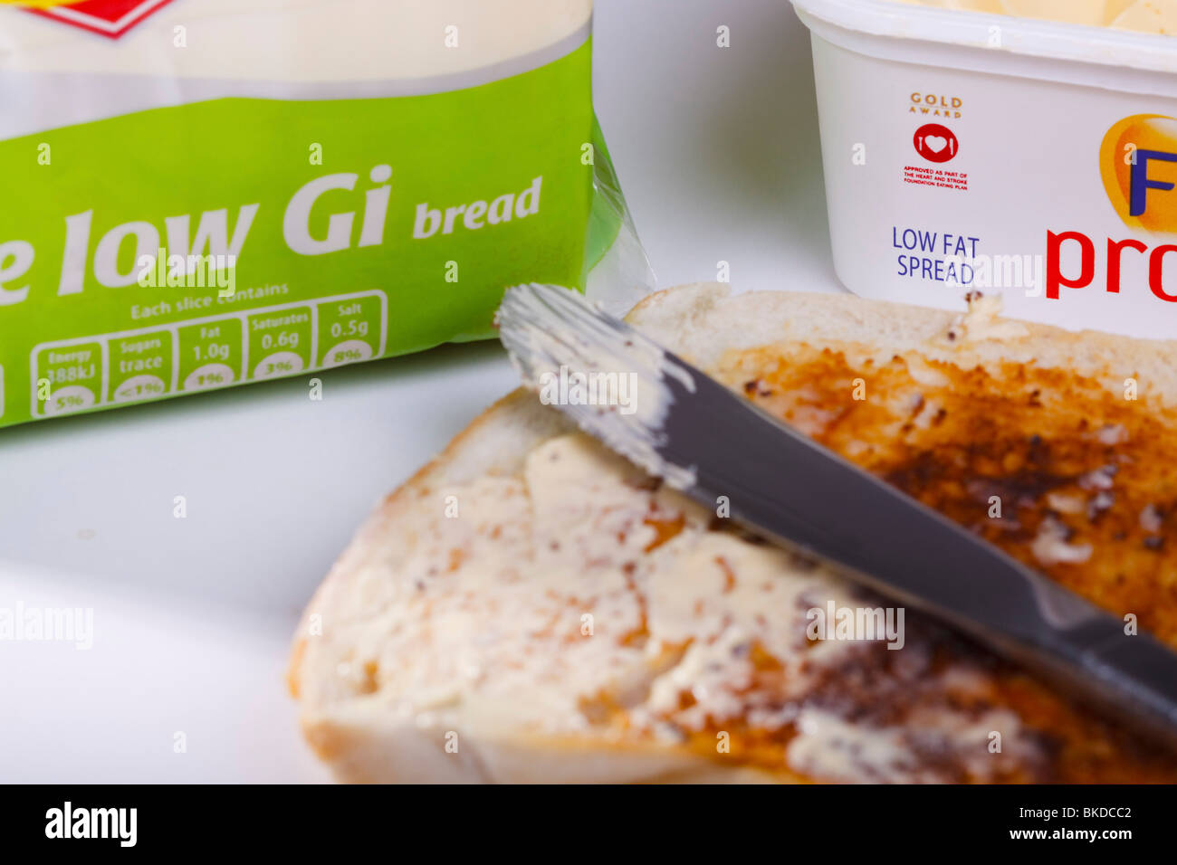 A slice of low Glycemic index toast spread with low fat margarine. Stock Photo