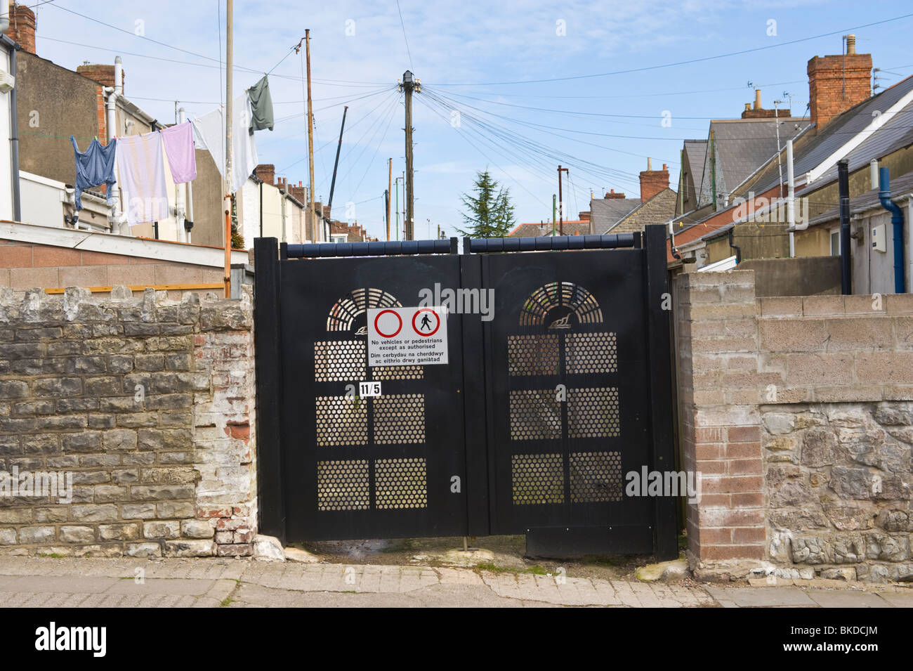 Security gates crime prevention measure at entrance to back lane between houses in Barry Vale of Glamorgan South Wales UK Stock Photo