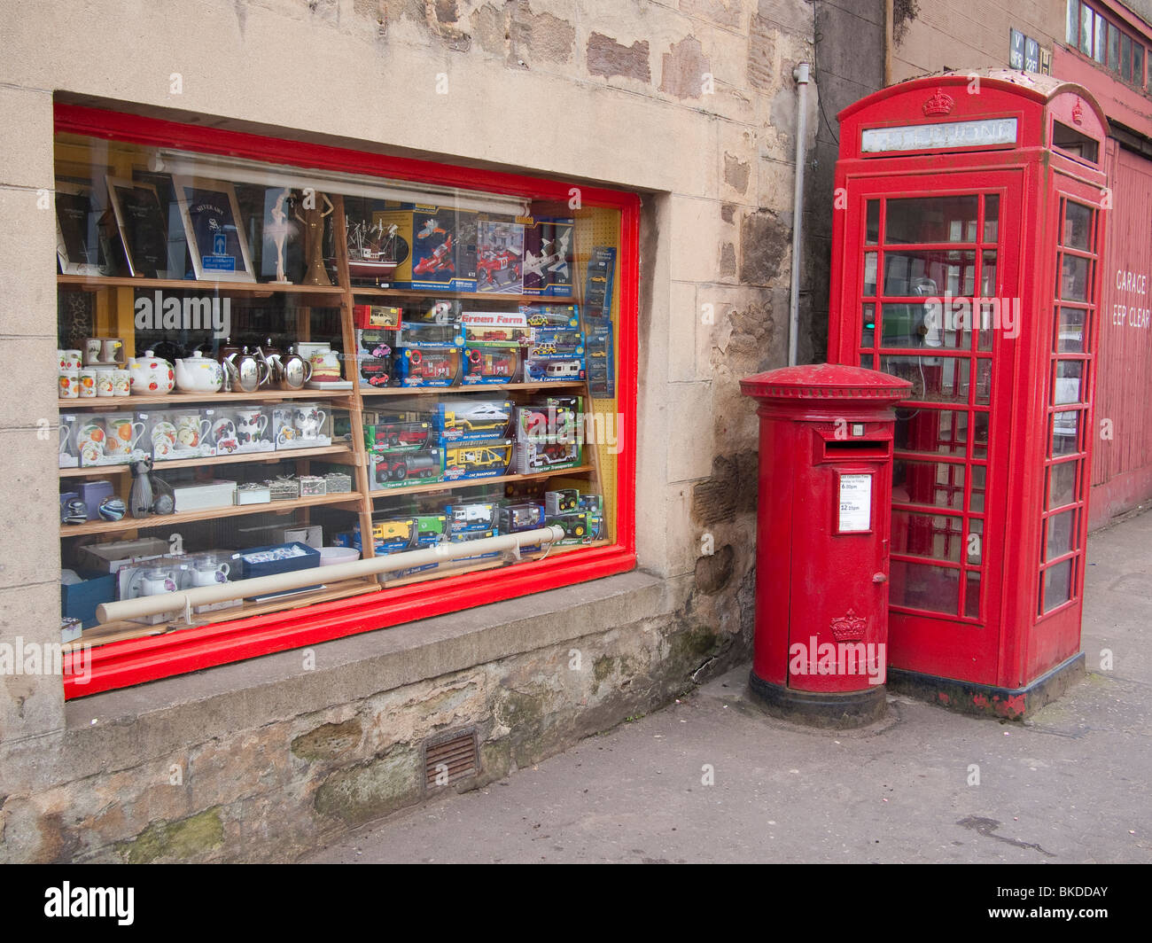 Red Pillar Box And Telephone Box Outside A Post Office  Uk