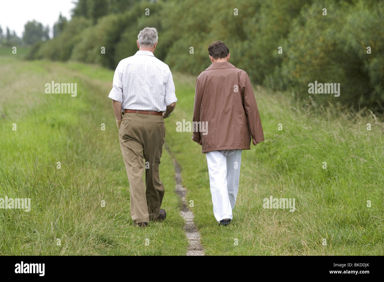 Couple walk in the countryside rear view Stock Photo - Alamy
