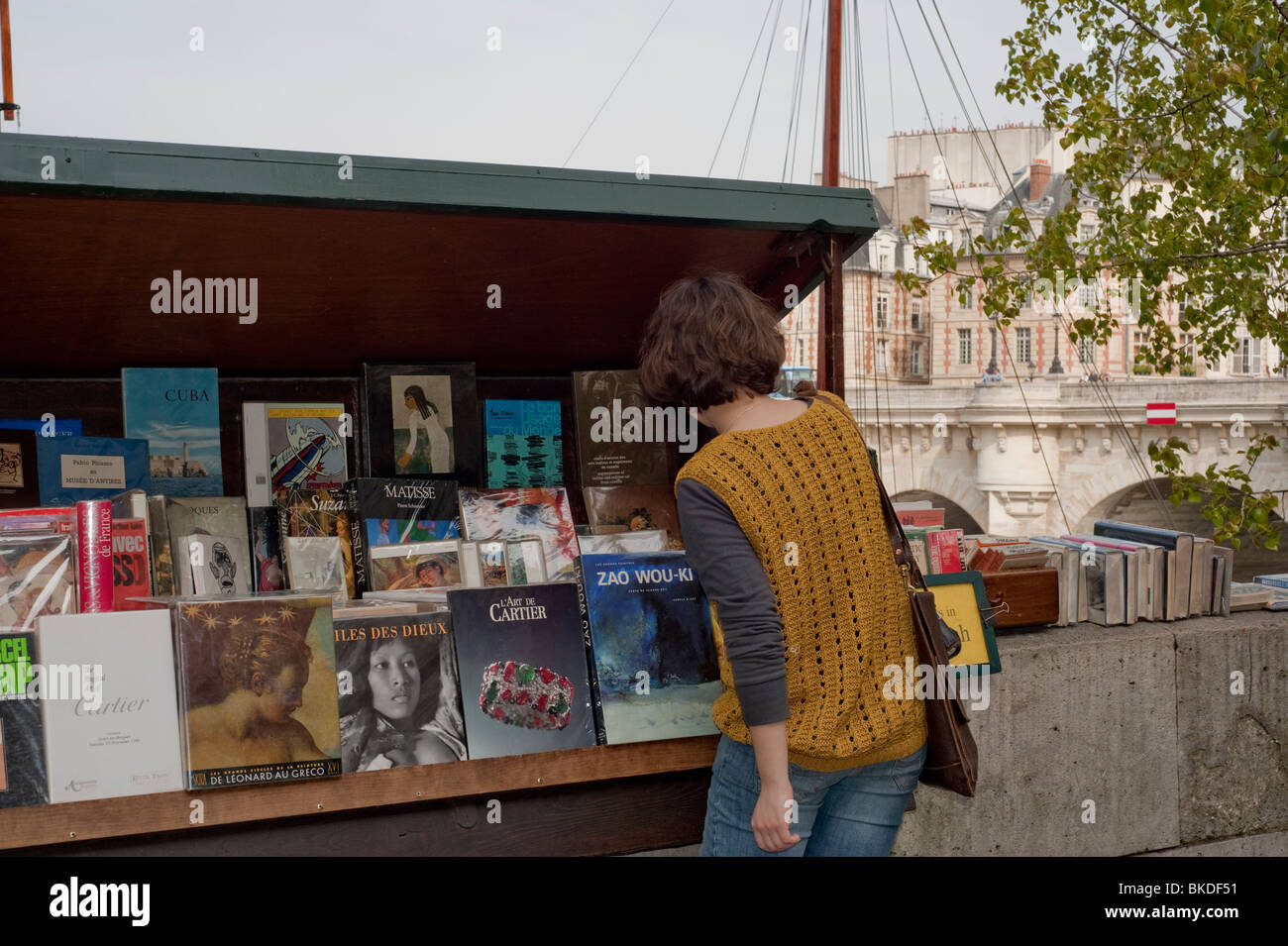 Woman Shopping, Old Books on Sale Outside Sidewalk Market, Paris, France, Seine River Quay, Bouquinistes, Antique Book Sellers Stock Photo