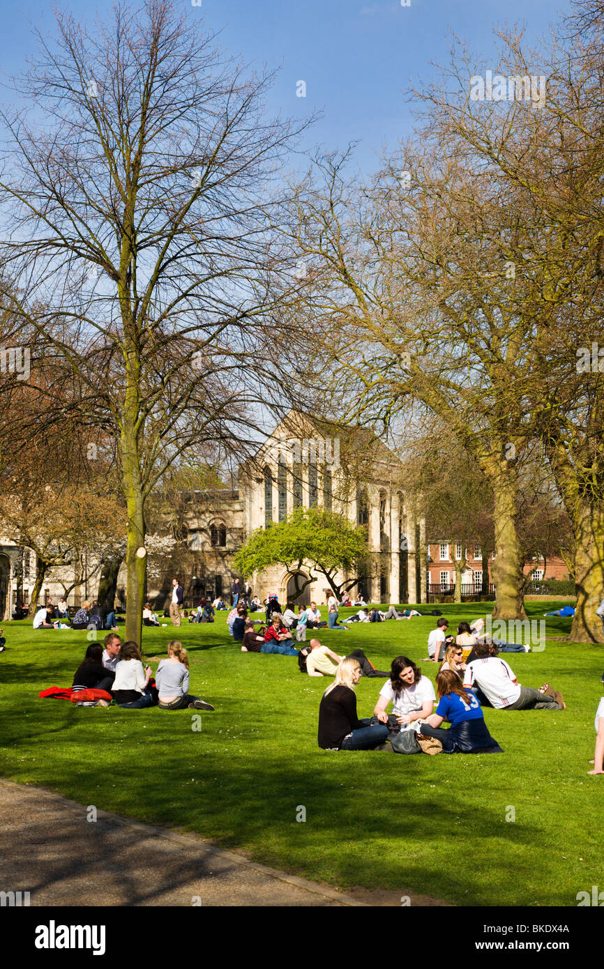 People sitting on the grass in Deans Park York Yorkshire UK Stock Photo