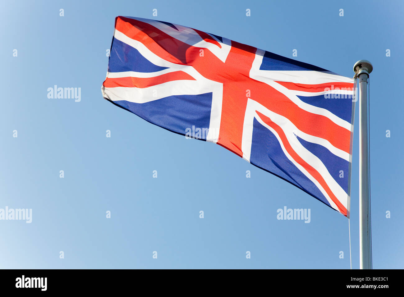 Union flag against a clear blue sky Stock Photo - Alamy