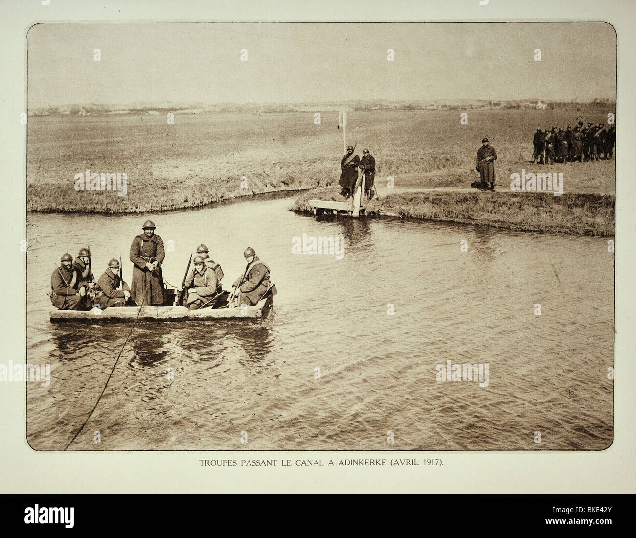 WW1 Belgian soldiers crossing canal by boat at Adinkerke in West Flanders during the First World War One, Belgium Stock Photo