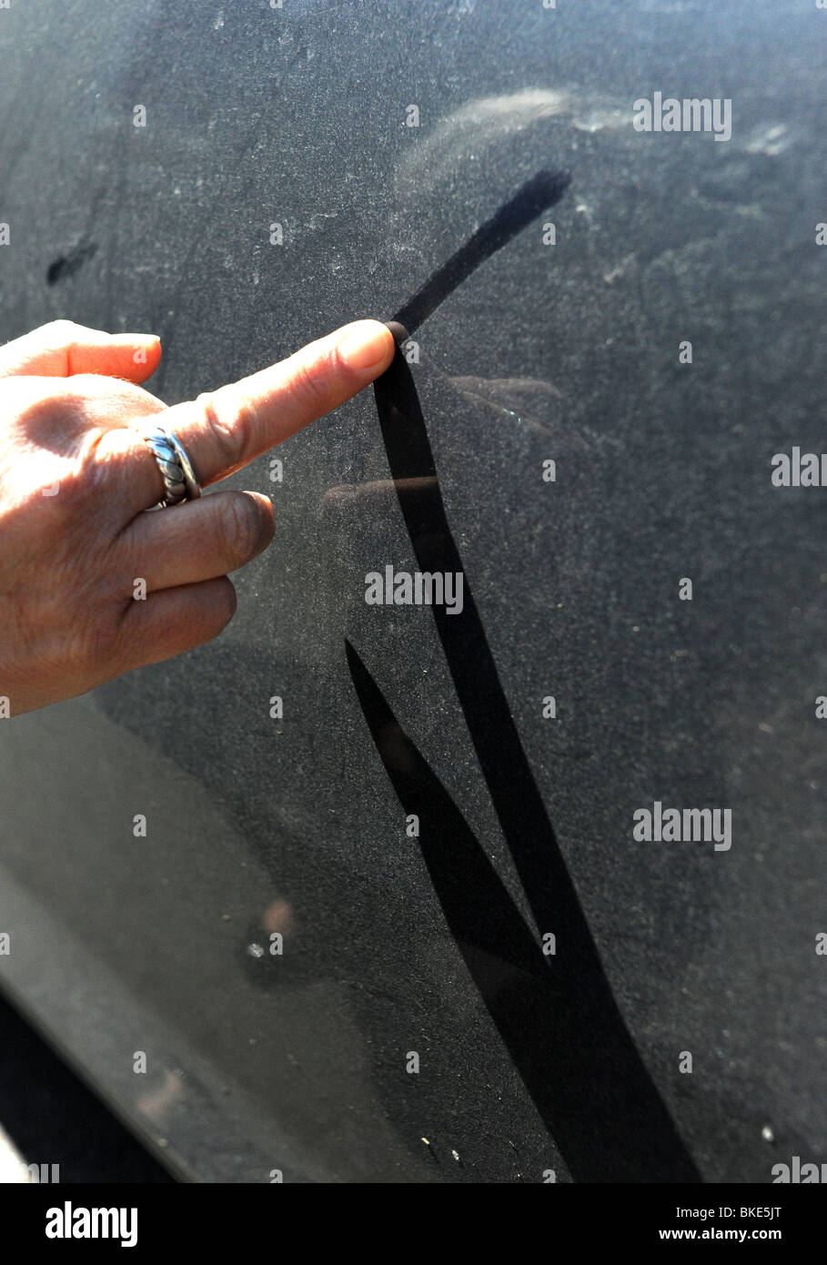 Message written in dust on a car caused by the volcanic ash from the eruption in Iceland April 2010 UK Stock Photo