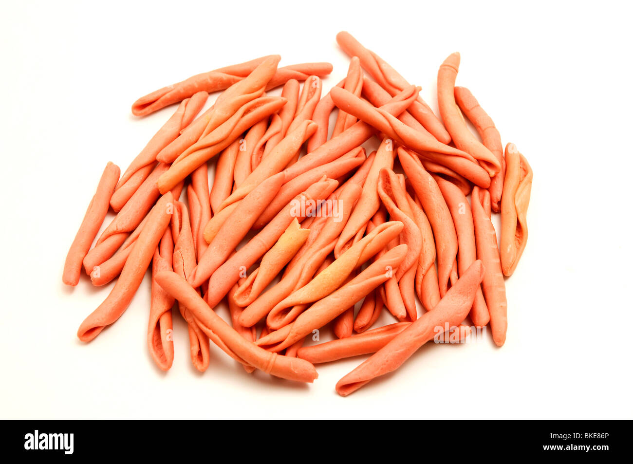 Red homemade fusilli on a white background Stock Photo