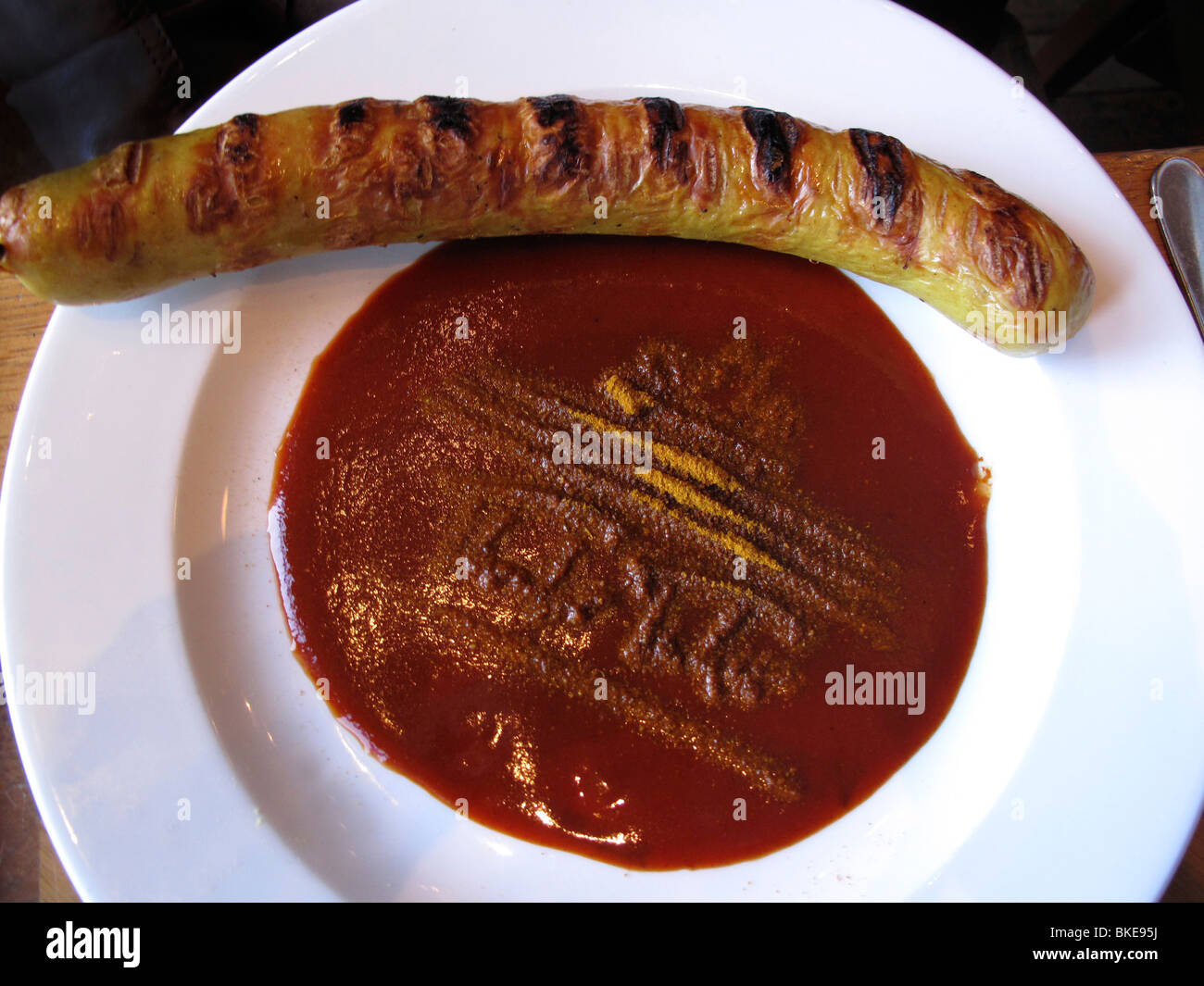 Fried sausage, Bratwurst with caurry sauce at Cafe Theodor Tucher, Pariser Platz, Brandenburg gate, Berlin Stock Photo