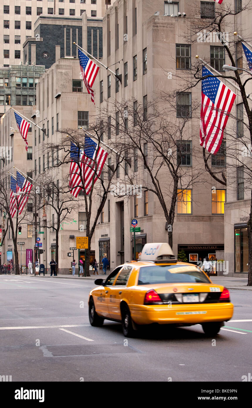 Lone Taxi Cab drives down 5th Avenue in Manhattan, New York City USA Stock Photo