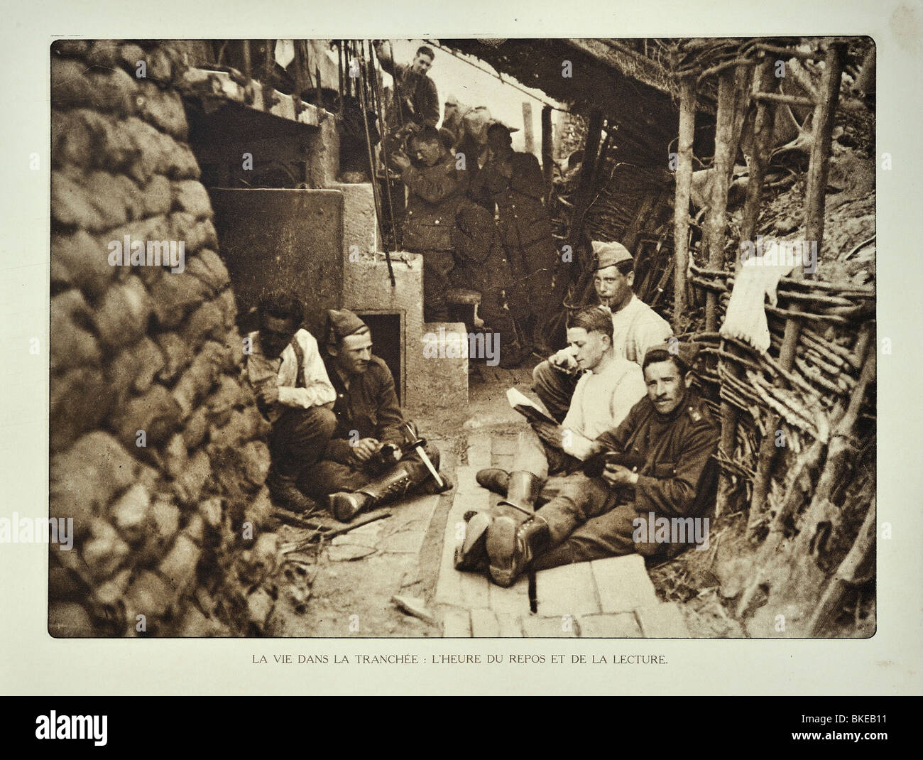 WW1 soldiers resting and reading books at shelter in trench in West Flanders during the First World War One, Belgium Stock Photo