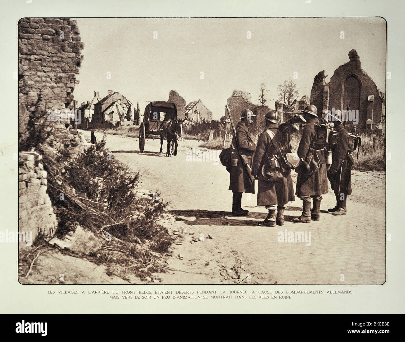 WWI Belgian soldiers on road  in ruined village after bombardment in West Flanders during the First World War One, Belgium Stock Photo