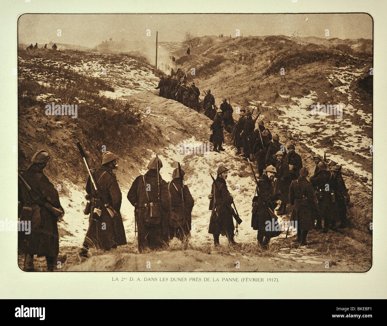 Belgian WW1 infantry soldiers marching through dunes in winter at De Panne in West Flanders during First World War One, Belgium Stock Photo