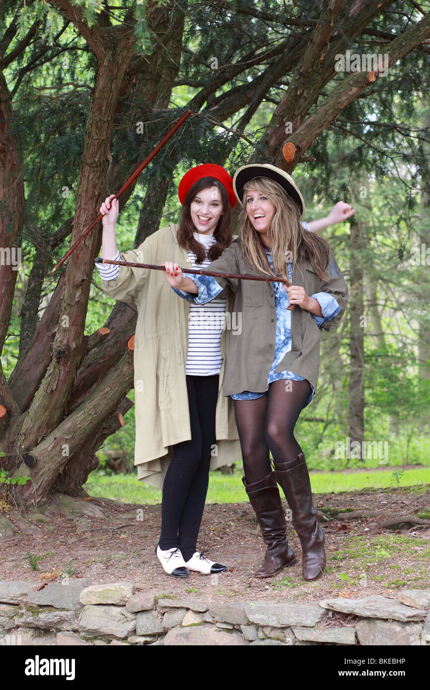 two stylish trendy fashionable young ladies dancing singing with canes
