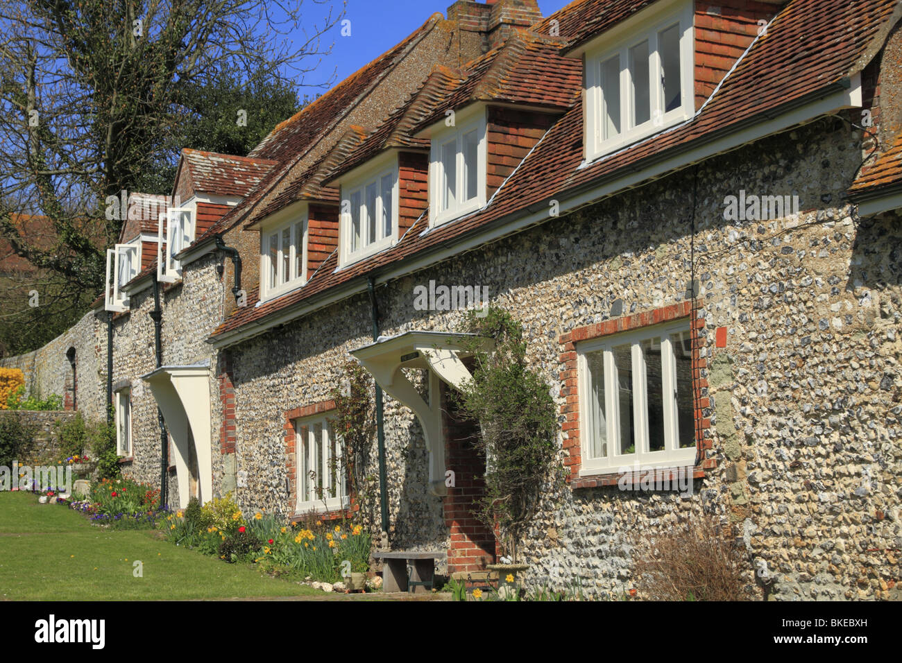 A terrace of traditional flint cottages, fronting onto the village