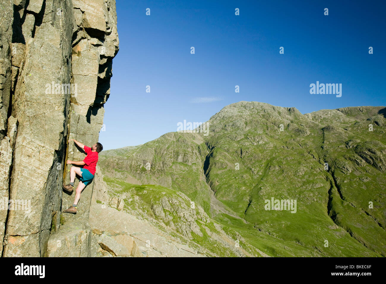 A man climbing on Great Gable in the Lake District UK Stock Photo