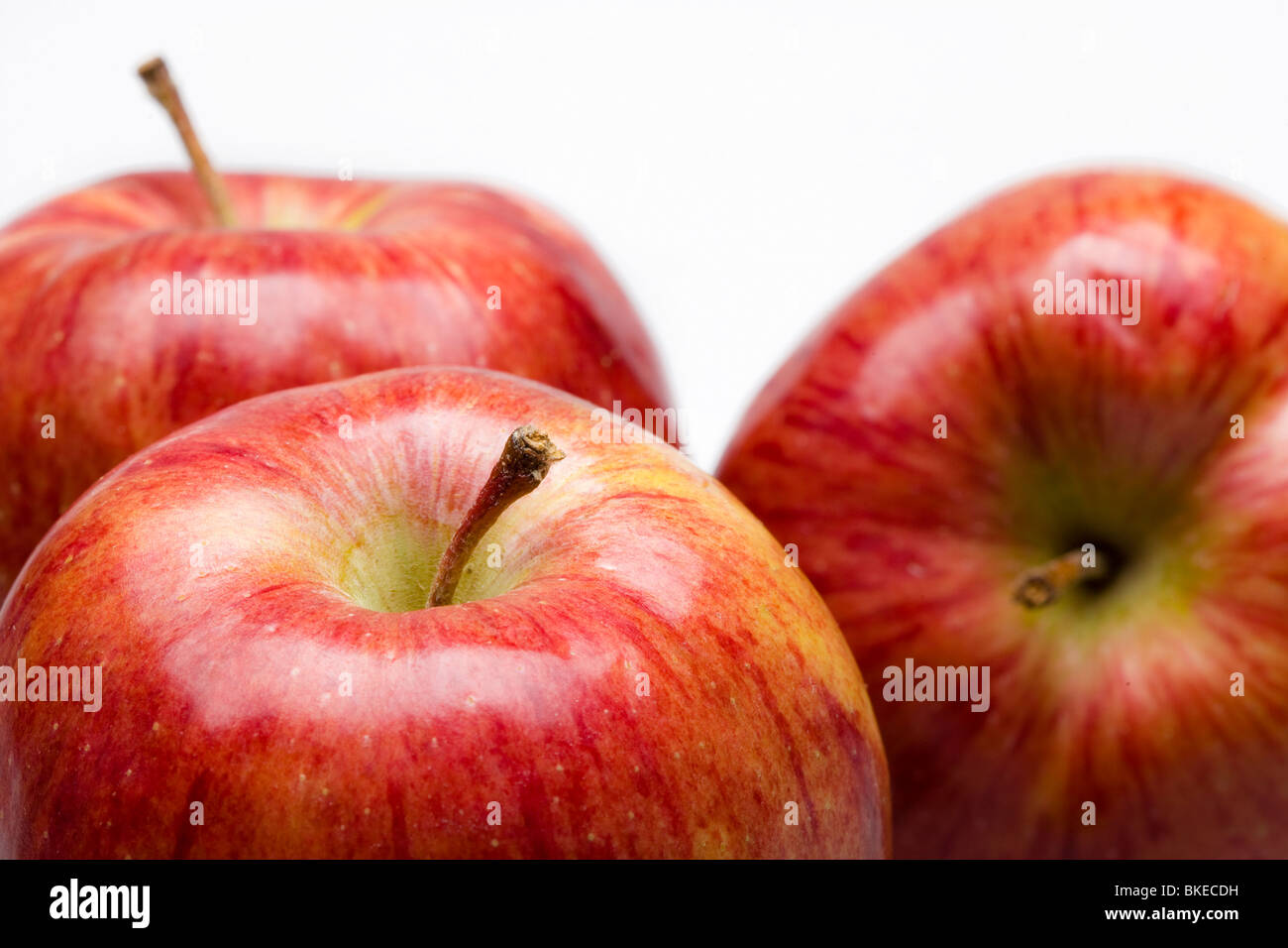 Three juicy apples on white background Stock Photo - Alamy