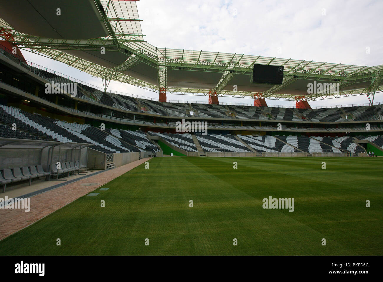 Interior of the Mbombela stadium In Nelspruit  at dusk showing the zebra-striped seating an a lush, green, playing surface Stock Photo