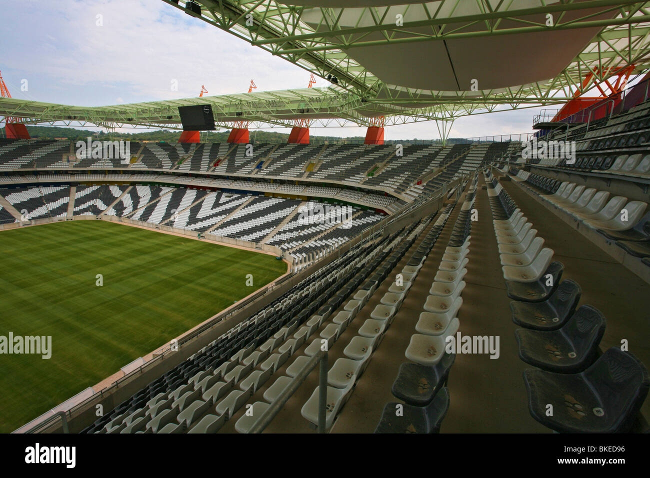 Interior of the Mbombela stadium In Nelspruit  showing the zebra-striped seating an a lush, green, playing surface Stock Photo