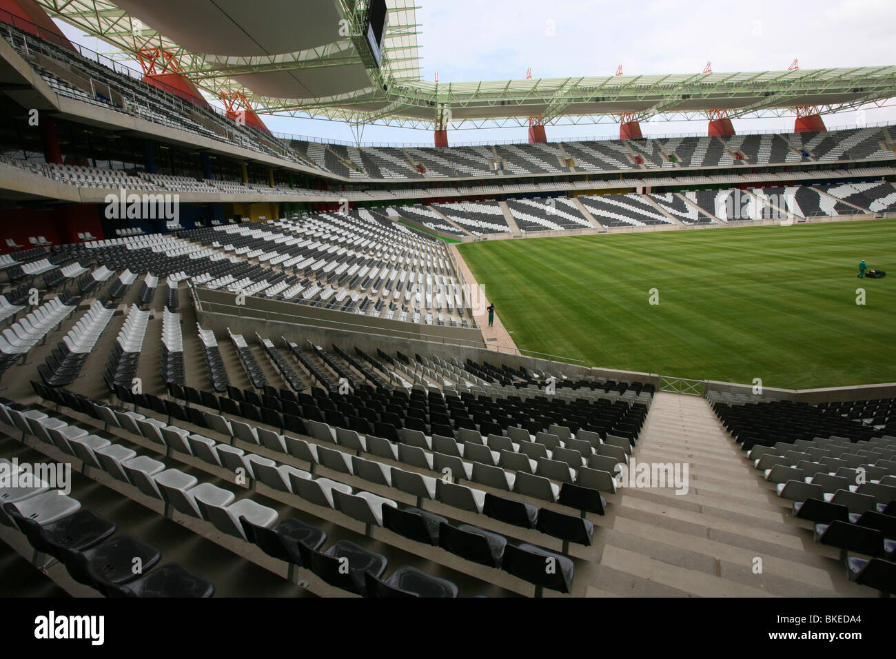 Interior of the Mbombela stadium In Nelspruit  showing the zebra-striped seating an a lush, green, playing surface Stock Photo