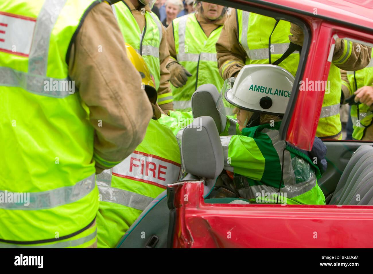 A paramedic treating a car crash victim in a training scenario for