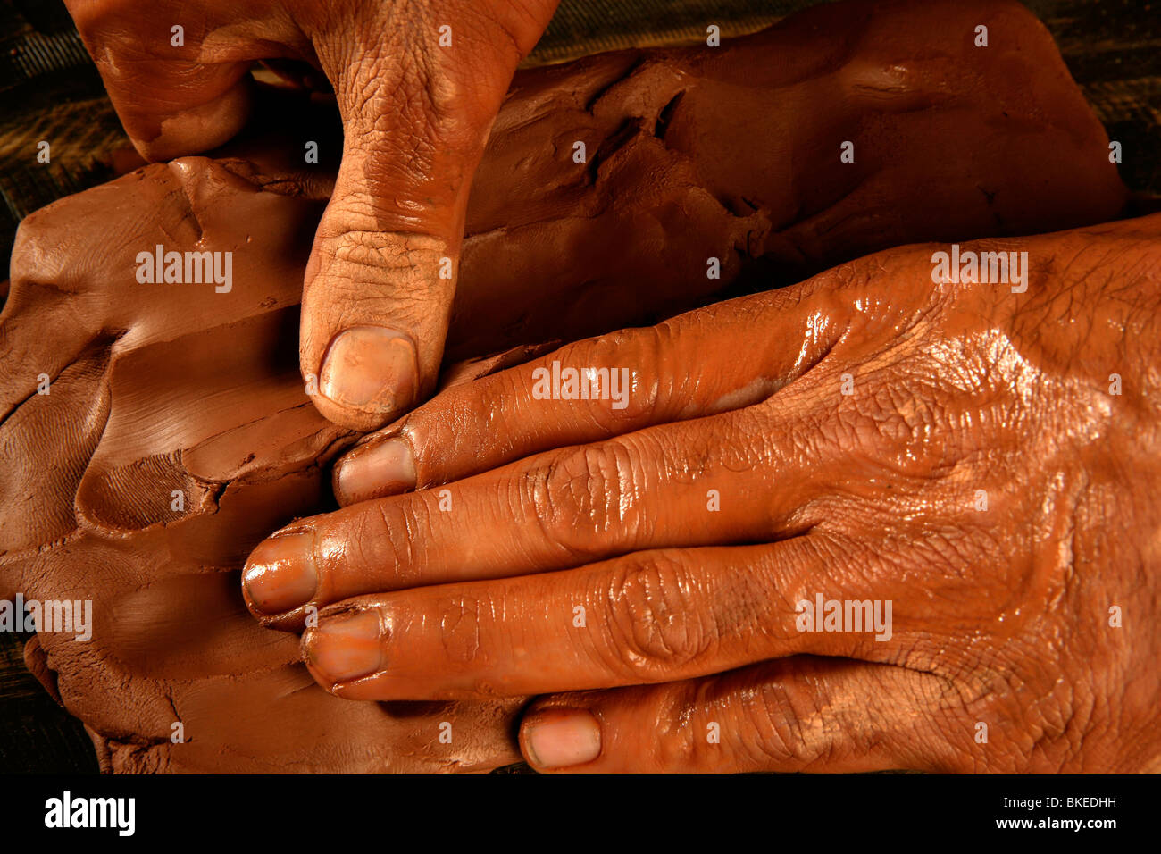 pottery craftsmanship potter craftsman hands working red clay Stock Photo