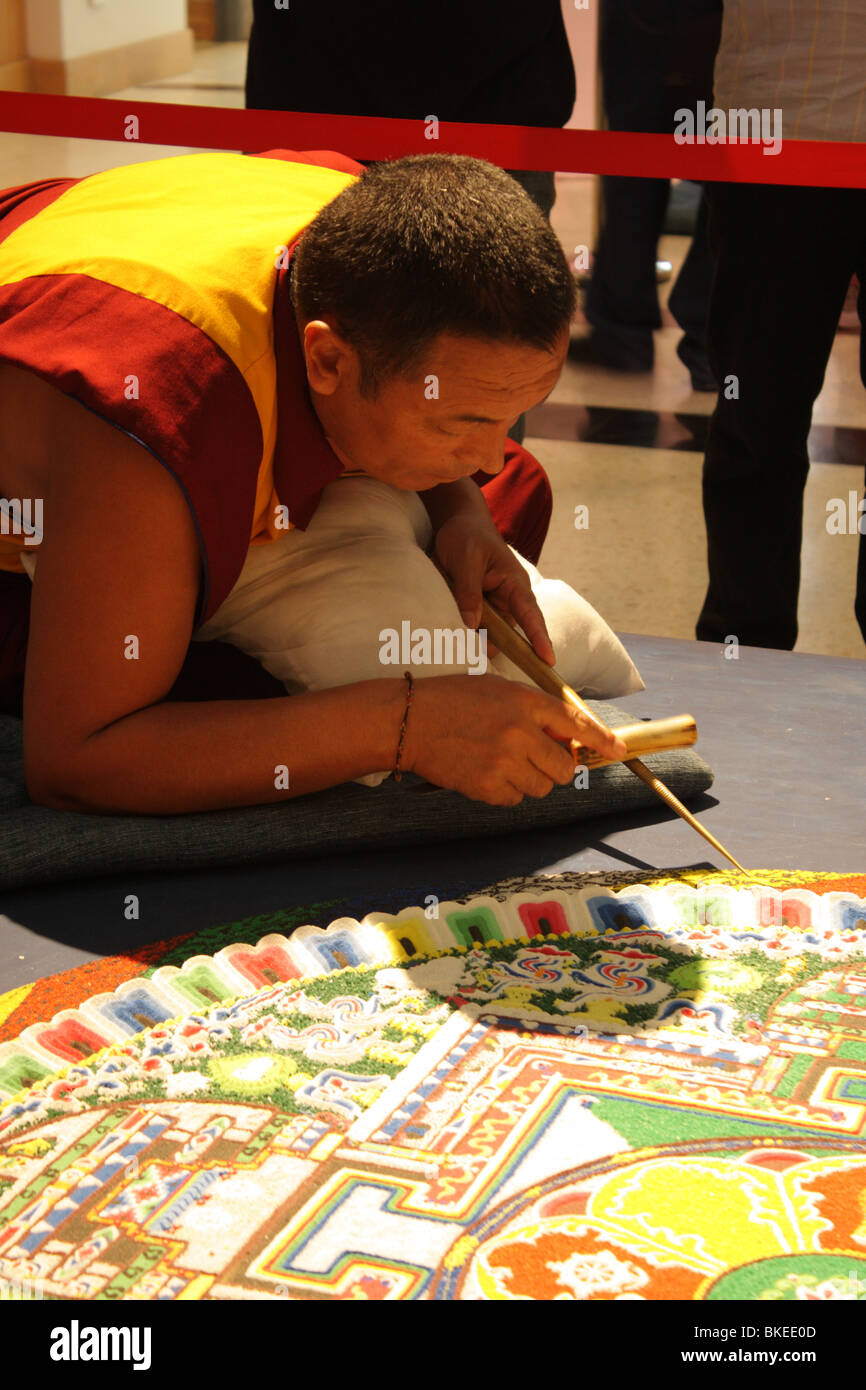 Tibetan monk working on sand mandala Stock Photo
