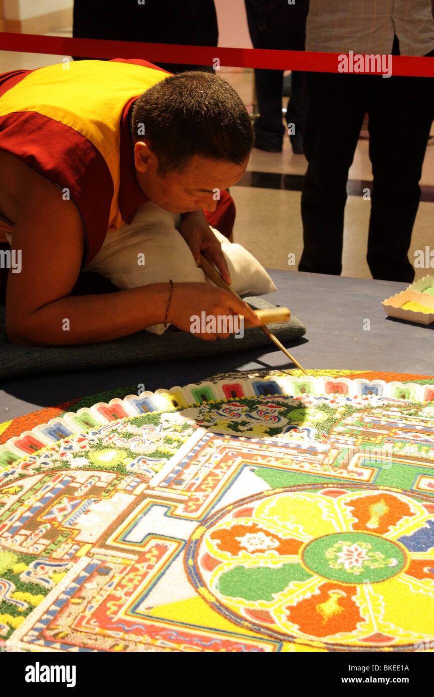 Tibetan monk working on sand mandala Stock Photo