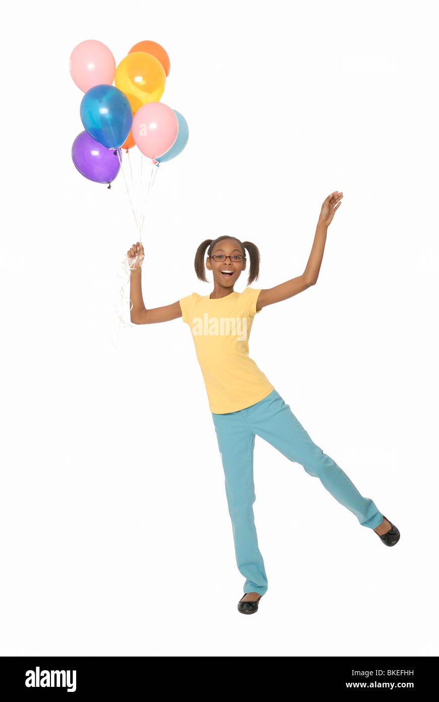 Ten year old girl holding balloons. Stock Photo