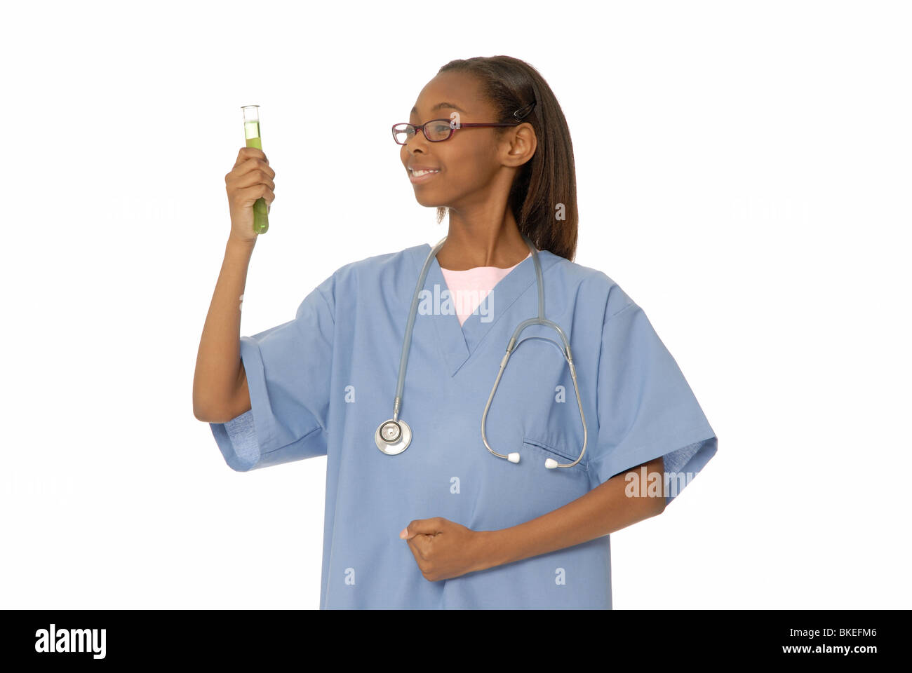 Ten year old girl dressed as a doctor, with a test tube or beaker. Stock Photo