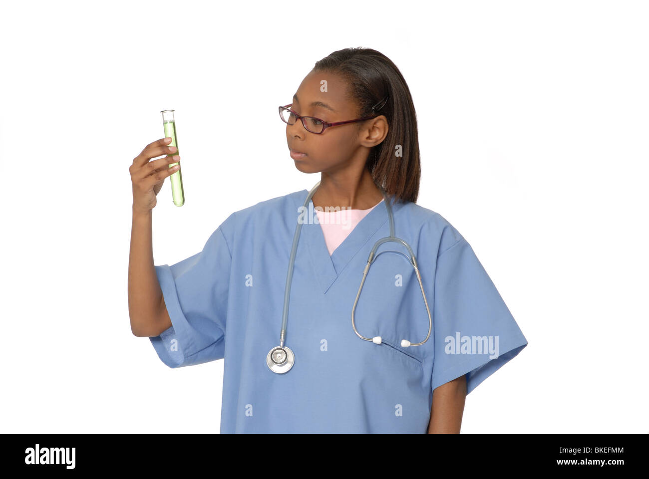 Ten year old girl dressed as a doctor, with a test tube or beaker. Stock Photo