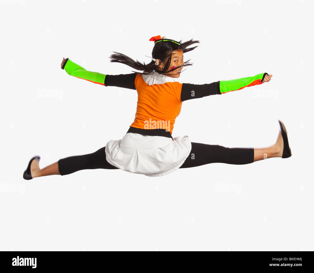 Girl Jumping With Legs And Arms Outstretched Stock Photo